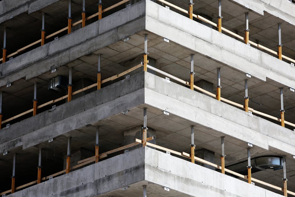 Close-up of an unfinished multi-level concrete building with steel reinforcements